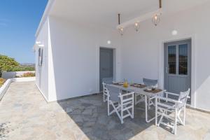a dining room with a table and chairs on a patio at Loulou House in Agia Kiriaki Beach