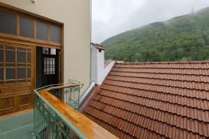a balcony with a door and a view of a mountain at 1910 Boutique Hotel in Braşov