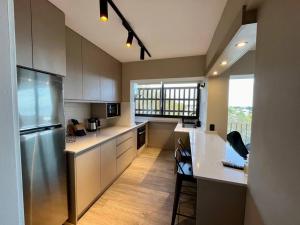 a kitchen with a refrigerator and a counter top at la vista in Colonia del Sacramento