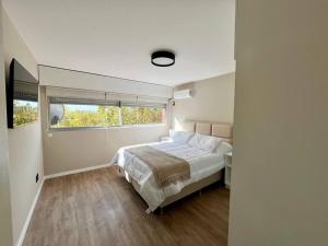 a bedroom with a bed and a window in it at la vista in Colonia del Sacramento