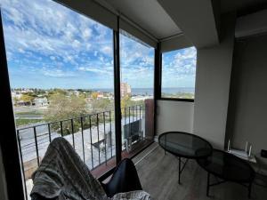 a room with a balcony with a view of the ocean at la vista in Colonia del Sacramento