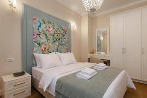 a bedroom with a bed with a painting on the wall at 1910 Boutique - Central, Scenic, Self Check-In in Braşov
