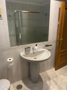 a bathroom with a sink and a mirror and a toilet at Casa del Carmen in Lorca +24 photos