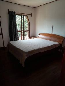 a bedroom with a large bed and a window at maison atypique, belle vue, belles chambres in Yaoundé