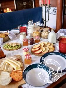 a table topped with different types of bread and food at Boat n Breakfast in Oeiras