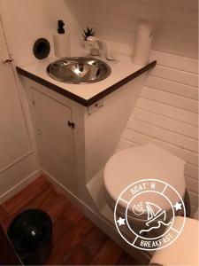 a small bathroom with a sink and a toilet at Boat n Breakfast in Oeiras