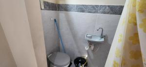 a small bathroom with a toilet and a sink at Suíte aconchegante e completa! Entrada independente em nova Iguaçu in Nova Iguaçu +3 photos
