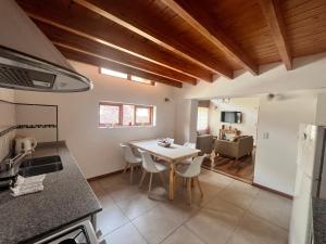 a kitchen and dining room with a table and chairs at Noreen Departamentos in San Martín de los Andes