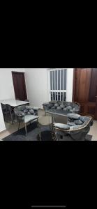 a living room with a table and a couch and chairs at Joli appartement ngor / Almadies in Ngor