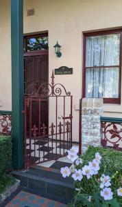a door to a house with flowers in front of it at The Bank House in Mount Victoria
