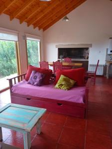 a living room with a purple couch and a table at Doña Hilaria in El Calafate