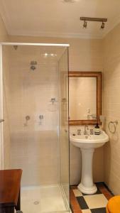 a bathroom with a shower and a sink at The Bank House in Mount Victoria