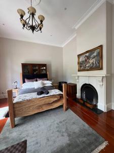 a bedroom with a large bed and a fireplace at The Bank House in Mount Victoria