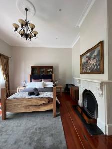a bedroom with a bed and a fireplace at The Bank House in Mount Victoria