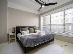 a bedroom with a large bed in a room with a window at Downtown Memphis Luxury Condo in Memphis