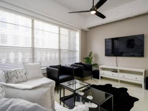 a living room with a couch and a tv at Downtown Memphis Luxury Condo in Memphis