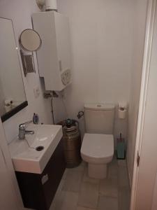 a small bathroom with a toilet and a sink at Casamar in Almería