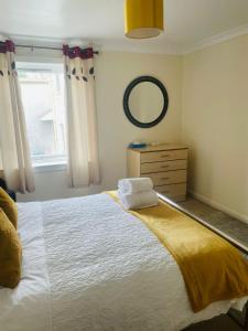 a bedroom with a large bed and a mirror at Wallace House in Fort William