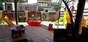 a backyard with a playground with a swing at Casa d' Alegra in Agios Ioannis
