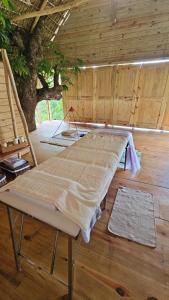 a bed in a room with a wooden floor at Margarita Ecovillage in Miches