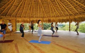 a group of people in a yoga class at Margarita Ecovillage in Miches