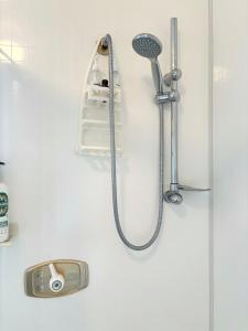 a shower with a shower head and a shower head at Home away from home in Christchurch