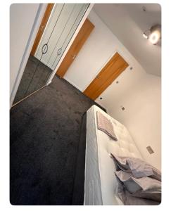 an attic room with a bed and a staircase at Giles Apart in Edinburgh