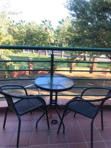 a table and two chairs sitting on a balcony at Palm29 at Sunset Mews, Grand Palm - self catering appartment - Your Ideal Getaway for Work or Relaxation in Gaborone