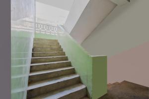 a staircase in a building with green and white walls at OYO Vibrant Inn in Patna