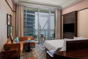 a hotel room with a bed and a large window at ITC Ratnadipa, a Luxury Collection Hotel, Colombo in Colombo
