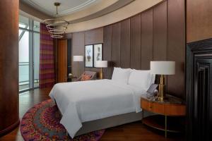 a bedroom with a large white bed and a table at ITC Ratnadipa, a Luxury Collection Hotel, Colombo in Colombo