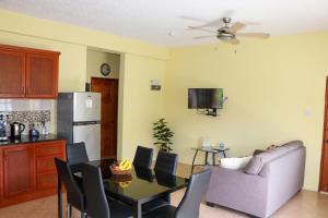 a kitchen and dining room with a table and a couch at Hidden Gem Apartments (No.5) in Castries