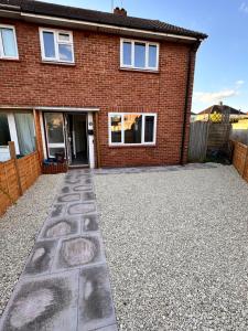 a brick house with a driveway in front of it at 9 probyn close in Bristol