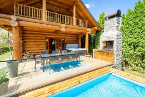 a log home with a swimming pool and a house at Holiday house with a swimming pool Brod na Kupi, Gorski kotar - 23012 in Brod na Kupi