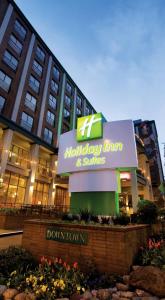 a building with a sign for a holiday inn and suites at Holiday Inn Vancouver Downtown & Suites, an IHG Hotel in Vancouver