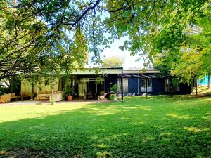 a house with a yard with green grass at Kelvin Maison's Haven in Johannesburg