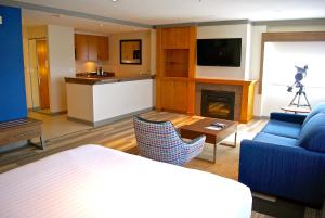 a living room with a blue couch and a fireplace at Holiday Inn Express Vancouver Airport-Richmond, an IHG Hotel in Richmond