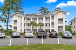 a large building with cars parked in a parking lot at Close to Beach, Ripken, Golf 2B-2B Condo in Myrtle Beach