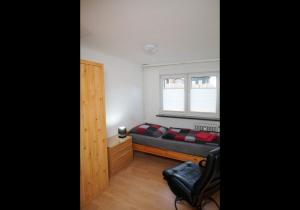 a small bedroom with a bed and a window at Schöne Unterkunft mit Billard in Meinerzhagen