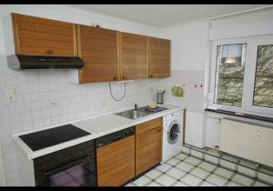 a small kitchen with a sink and a dishwasher at Schöne Unterkunft mit Billard in Meinerzhagen