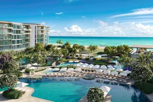 an aerial view of a resort with a pool and the ocean at The St Regis Longboat Key Resort in Longboat Key