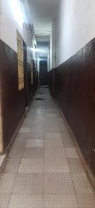 an empty hallway in a building with a tile floor at SPOT ON Gajadhar Rest House in Deoghar