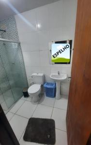 a bathroom with a shower and a toilet and a sink at Casa Buzios do Francês in Marechal Deodoro