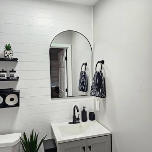 a bathroom with a sink and a mirror at Atlantic City Bungalow Retreat in Atlantic City