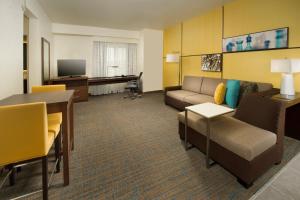 a living room with a couch and a table at Residence Inn by Marriott Tyler in Tyler
