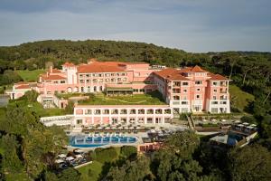an aerial view of a large pink building with a pool at Penha Longa Resort in Sintra