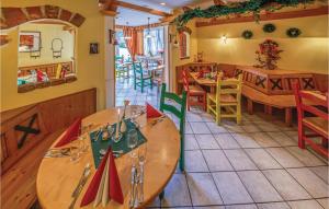 a restaurant with a table and chairs and a dining room at Beautiful Home In St,georgen Am Kreischb, With 2 Bedrooms, Wifi And Indoor Swimming Pool in Sankt Lorenzen ob Murau