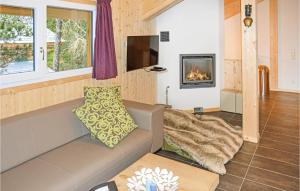 a living room with a couch and a fireplace at Awesome Home In Turrach With 5 Bedrooms And Sauna in Turracher Hohe