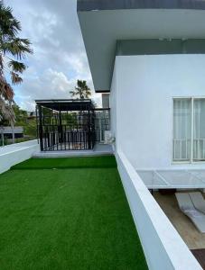 努沙杜瓦3 BR Chrysanthemum Villa nusadua的绿草丛中阳台 更多32张照片