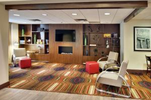 a waiting room with chairs and a large rug at Four Points by Sheraton Nashville Airport in Nashville